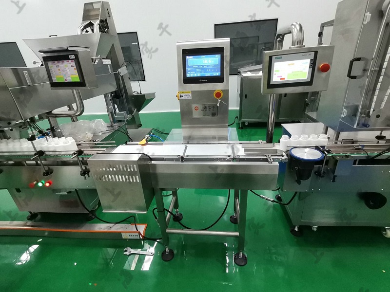 Pharmaceutical tube checkweigher